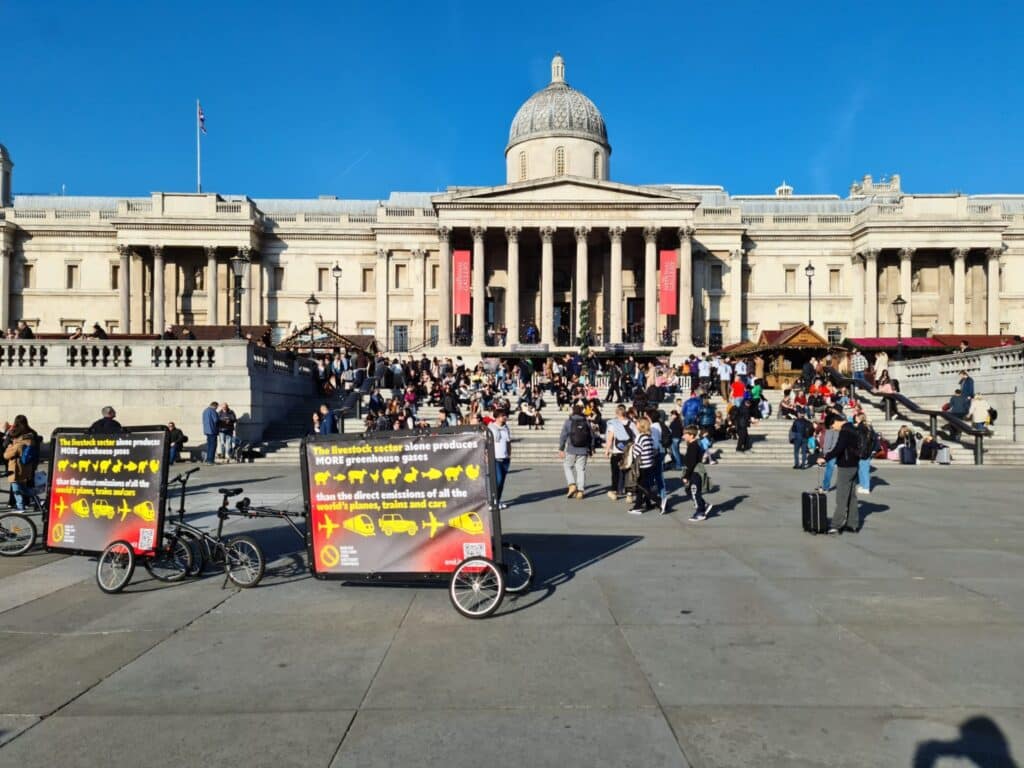 Compassion in World Farming posters on advertising bike trailers in Trafalgar Square
