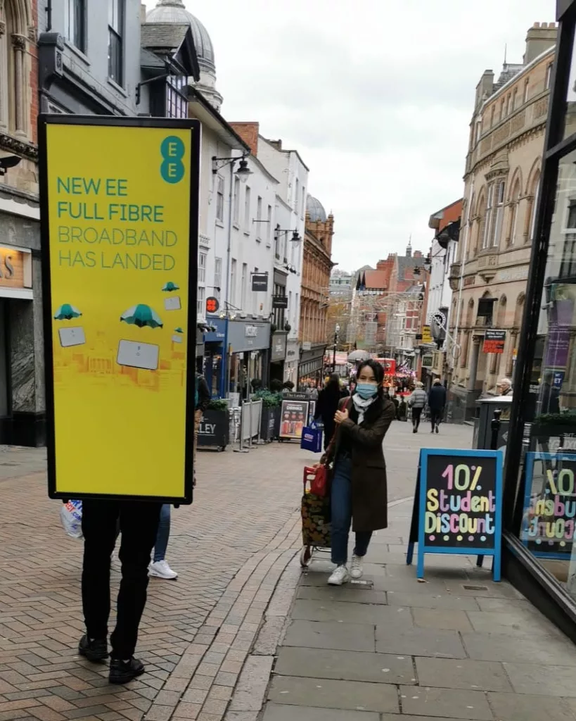 EE full-fibre creative on a human billboard display