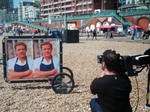 Food Unwrapped filming activity using an ad bike on Brighton Beach
